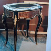 Table vitrine laquée noir et rouge, restauration de bronzes dorés